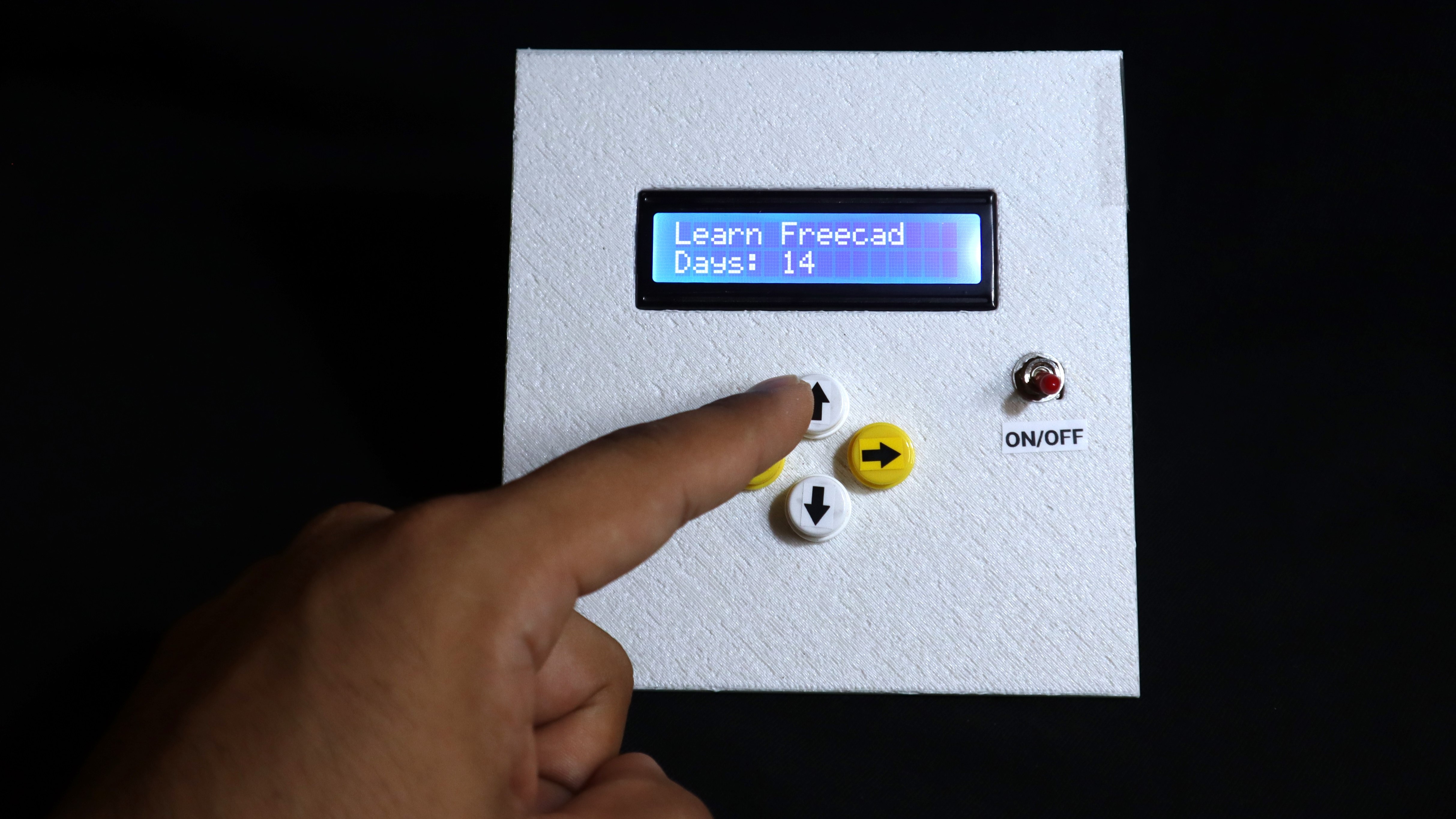 Habit tracker facing toward front, displaying the message learn Freecad, and pressing the up button.